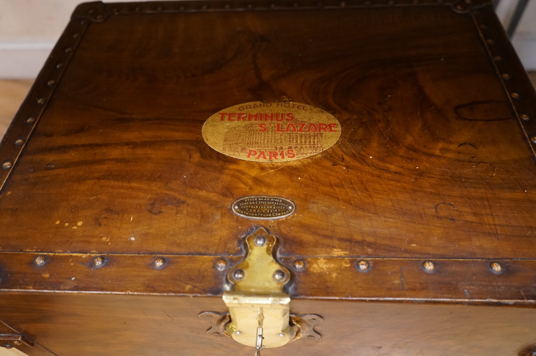 A Hartman Trunk Company metal travelling secretaire with The Grand Hotel, Paris label, with key, 52cm wide